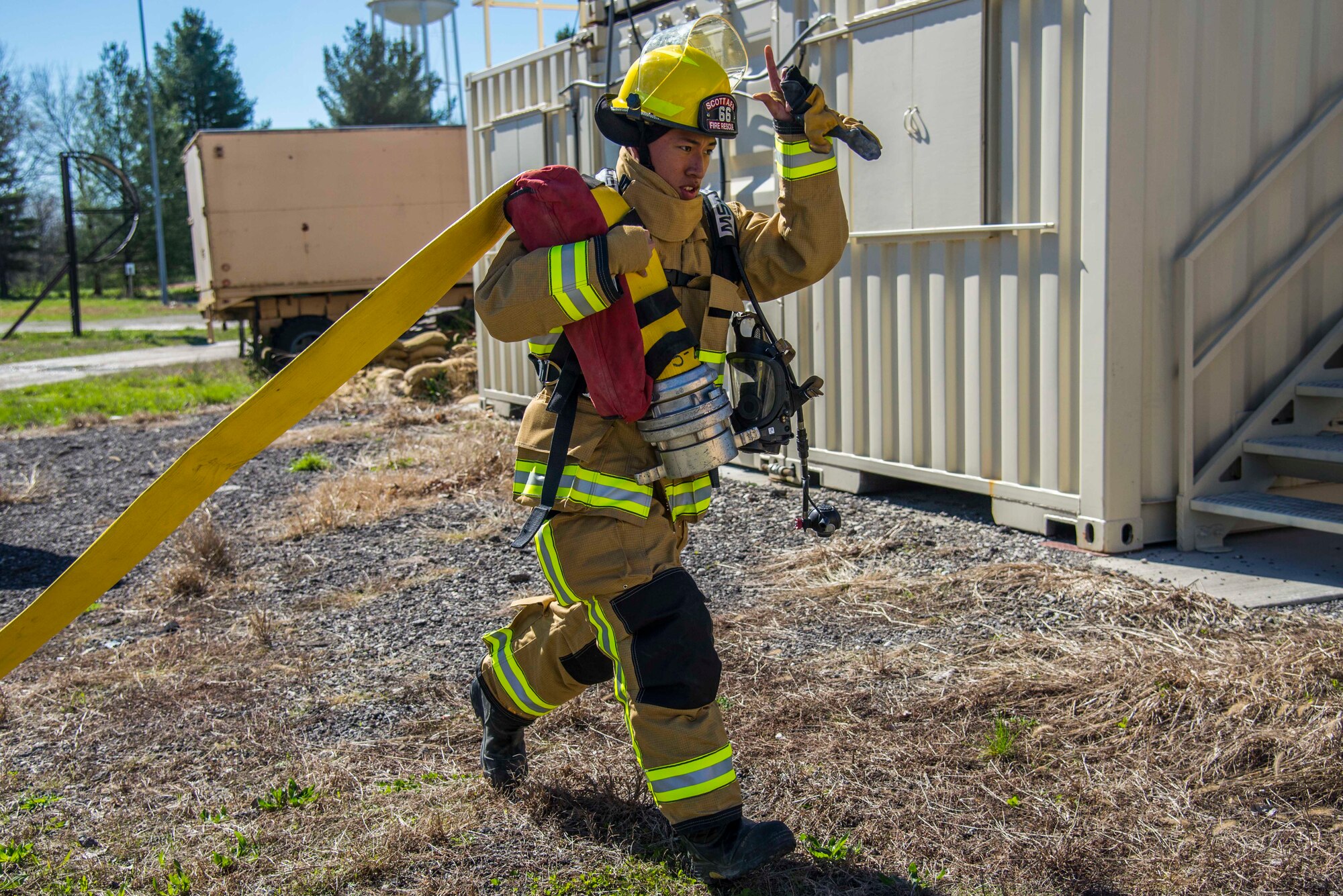 Firefighters with the 375th Civil Engineer Squadron performed drills in new structural gear at Scott. The new gear has a constructed outer shell capable of withstanding 1,100-1,200 degrees before degrading to the point of losing complete physical integrity. The thermal liner consist of two primary components that allow better moisture absorbency and allows sweat to be removed. Helmets are made smaller to offset risks associated with confined spaces or while wearing the self-contained breathing apparatus, and footwear has a steel toe with safety toe protection.