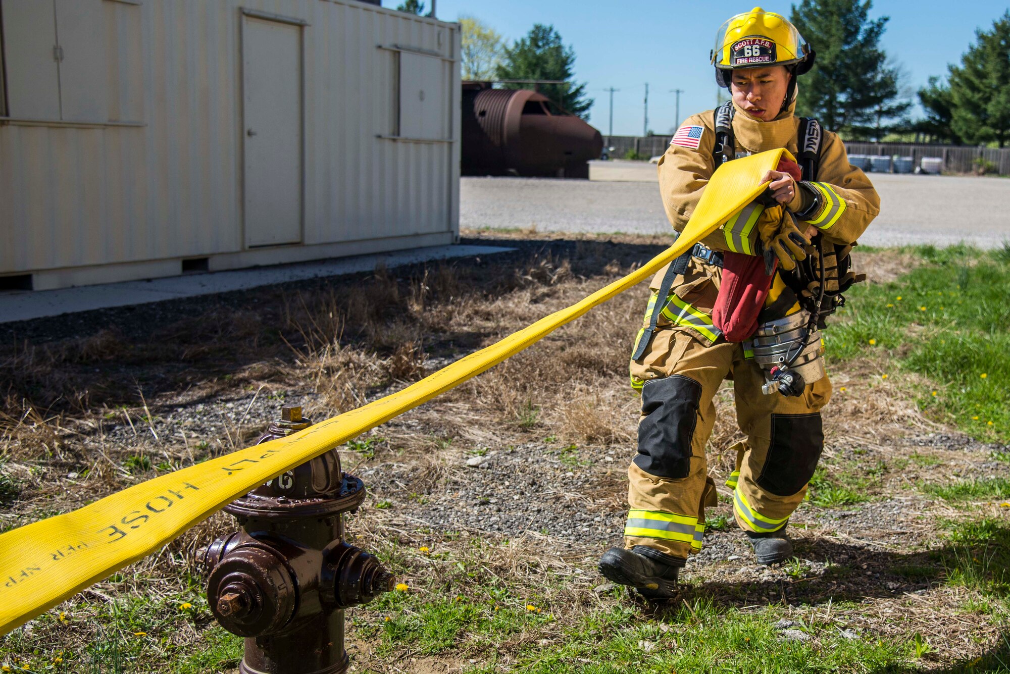 Firefighters with the 375th Civil Engineer Squadron performed drills in new structural gear at Scott. The new gear has a constructed outer shell capable of withstanding 1,100-1,200 degrees before degrading to the point of losing complete physical integrity. The thermal liner consist of two primary components that allow better moisture absorbency and allows sweat to be removed. Helmets are made smaller to offset risks associated with confined spaces or while wearing the self-contained breathing apparatus, and footwear has a steel toe with safety toe protection.
