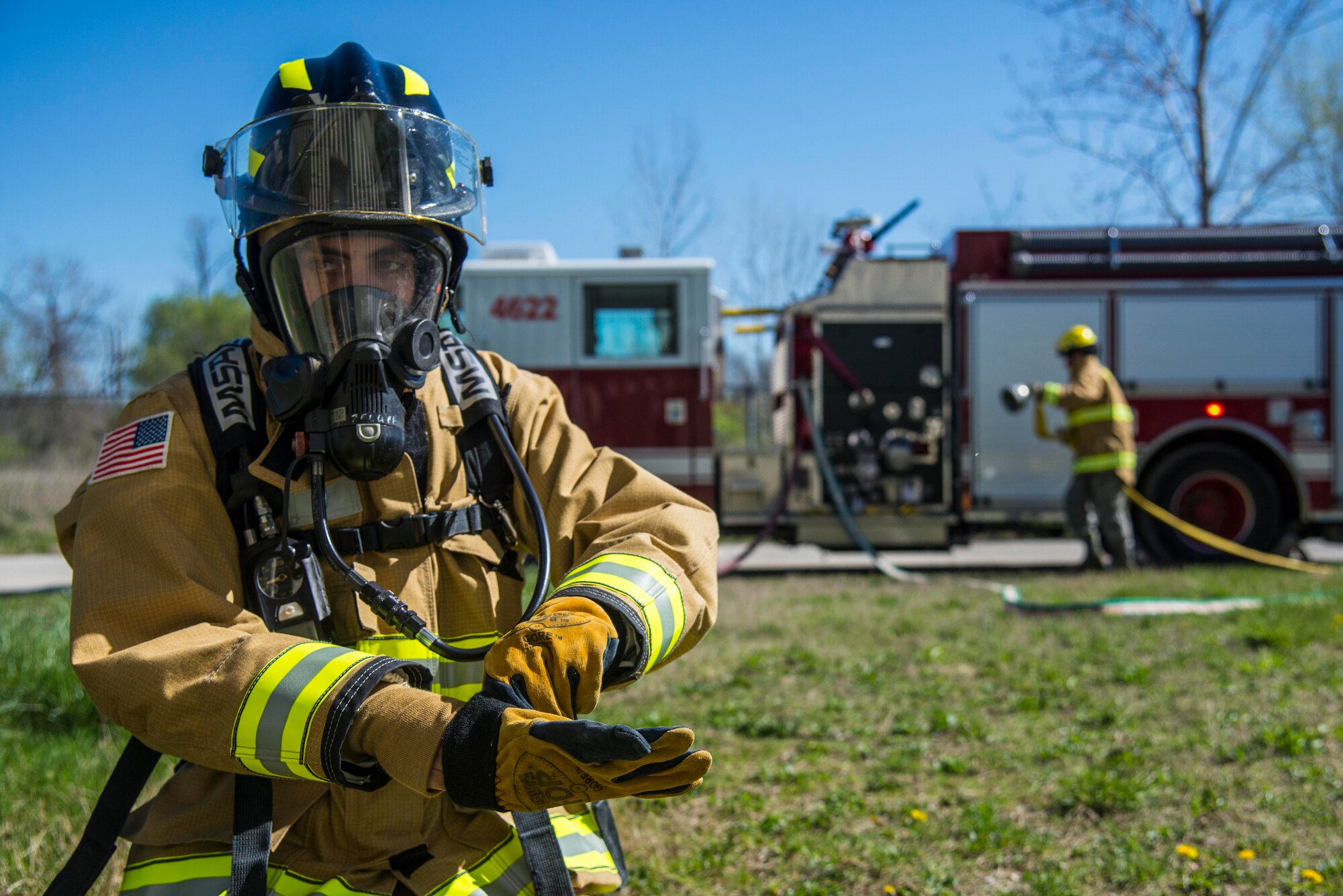 Firefighters with the 375th Civil Engineer Squadron performed drills in new structural gear at Scott. The new gear has a constructed outer shell capable of withstanding 1,100-1,200 degrees before degrading to the point of losing complete physical integrity. The thermal liner consist of two primary components that allow better moisture absorbency and allows sweat to be removed. Helmets are made smaller to offset risks associated with confined spaces or while wearing the self-contained breathing apparatus, and footwear has a steel toe with safety toe protection.