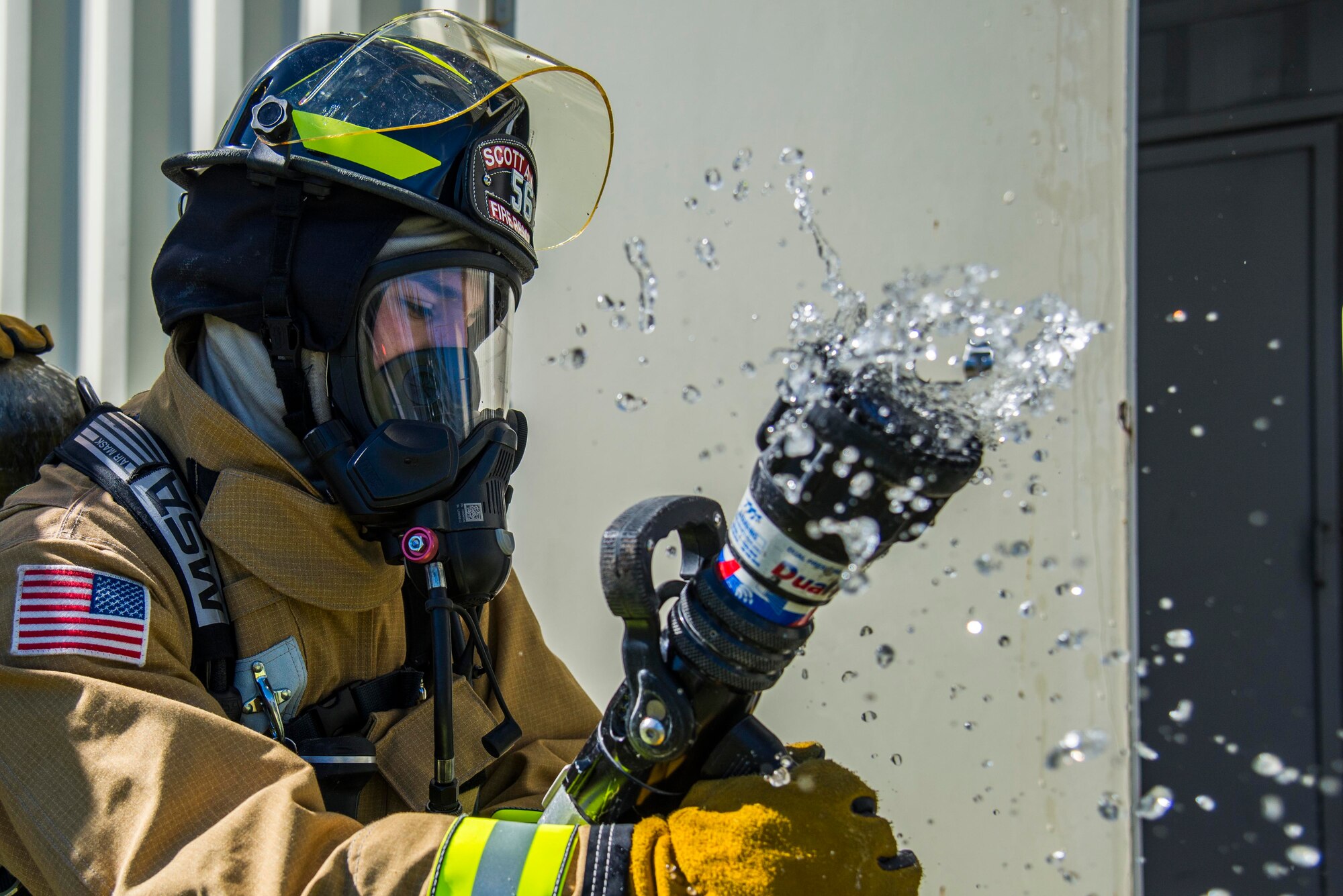 Firefighters with the 375th Civil Engineer Squadron performed drills in new structural gear at Scott. The new gear has a constructed outer shell capable of withstanding 1,100-1,200 degrees before degrading to the point of losing complete physical integrity. The thermal liner consist of two primary components that allow better moisture absorbency and allows sweat to be removed. Helmets are made smaller to offset risks associated with confined spaces or while wearing the self-contained breathing apparatus, and footwear has a steel toe with safety toe protection.