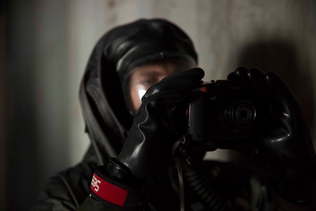 TUNNEL HILL, Ga. – Cpl. Bryan Griemeverslues, a hazmat technician with Chemical Biological Radiological Nuclear Platoon, Combat Logistics Regiment 4, 4th Marine Logistics Group, Marine Forces Reserve, documents a potentially dangerous building during a CBRN training exercise at Volunteer Training Site, Catoosa, Tunnel Hill, Ga., April 4, 2017. While in an area where the circumstances of the environment are unknown, the CBRN Marines document everything they see because they are the first reconnaissance team to access the area.  Photos and sketch pads are used to document details collected from every room to brief the rest of their platoon after they return to the combat operations center.  (U.S. Marine Corps photo by Cpl. Devan Alonzo Barnett/Released)