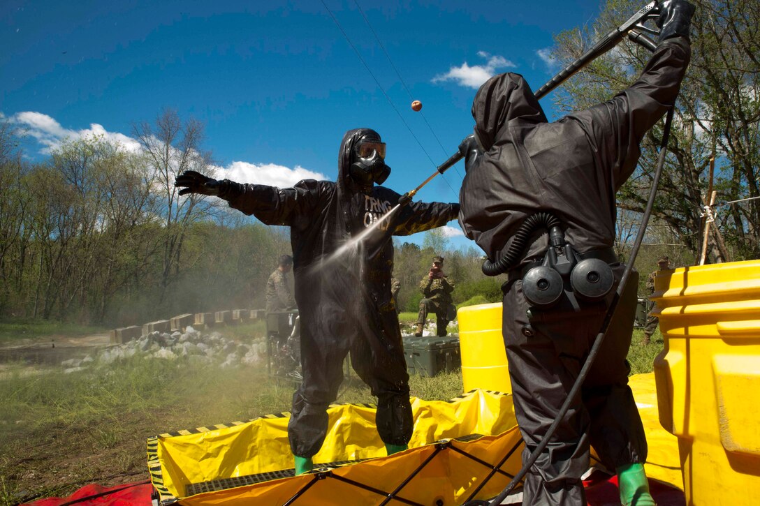 TUNNEL HILL, Ga. – Staff Sgt. Jarrod Tepe, a platoon sergeant with Personal Retrieval and Processing Company, Combat Logistics Regiment 45, 4th Marine Logistics Group, Marine Forces Reserve, gets decontaminated and sprayed down by Lance Cpl. Jacob Jones, a hazmat technician with Chemical Biological Radiological Nuclear Platoon, Combat Logistics Regiment 4, 4th Marine Logistics Group, Marine Forces Reserve, during a joint operations training exercise at Volunteer Training Site, Catoosa, Tunnel Hill, Ga., April 8, 2017. The exercise concluded by combining the CBRN Marines with the PRP Marines to practice what they would need to do if a deceased service member was contaminated and needed to be returned home. (U.S. Marine Corps photo by Cpl. Devan Alonzo Barnett/Released)