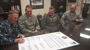 From left to right: U.S. Navy Capt. Robert Hudson, Naval Support Activity Charleston commander, U.S. Air Force Col. Robert Lyman, 628th Air Base Wing commander, U.S. Air Force Col. Gregory Gilmour, 315th Airlift Wing commander and U.S. Air Force Col. Jimmy Canlas, 437th Airlift Wing commander, sign a proclamation declaring April as Sexual Assault Awareness & Prevention Month April 4, 2017, in the Headquarters Conference Room here. SAAPM is observed across the Department of Defense annually to focus on creating an appropriate culture and eliminating sexual assault through a personal commitment from all service members at every level.
