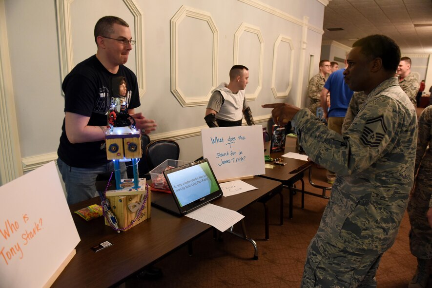 Tech. Sgt. Samuel Finch, 4th Component Maintenance Squadron support section NCO in charge (left), represents the Trivia club and quizzes Senior Master Sgt. Donald Winchester, 4th Civil Engineer Squadron superintendent (right), during MIBCON17, March 31, 2017, at Seymour Johnson Air Force Base, North Carolina. More than 40 clubs were on display for Airmen and their families to gain more information and possibly join. (U.S. Air Force photo by Airman 1st Class Kenneth Boyton)