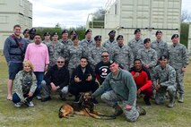 Members of the 633rd Security Forces Squadron take a photo with UFC fighters, MMAjunkie Radio hosts and Jacob “Stitch” Duran during their visit to Joint Base Langley-Eustis, Va., April 7, 2017. The group learned about techniques and teamwork by clearing a building during their visit. (U.S. Air Force photo/Senior Airman Derek Seifert)