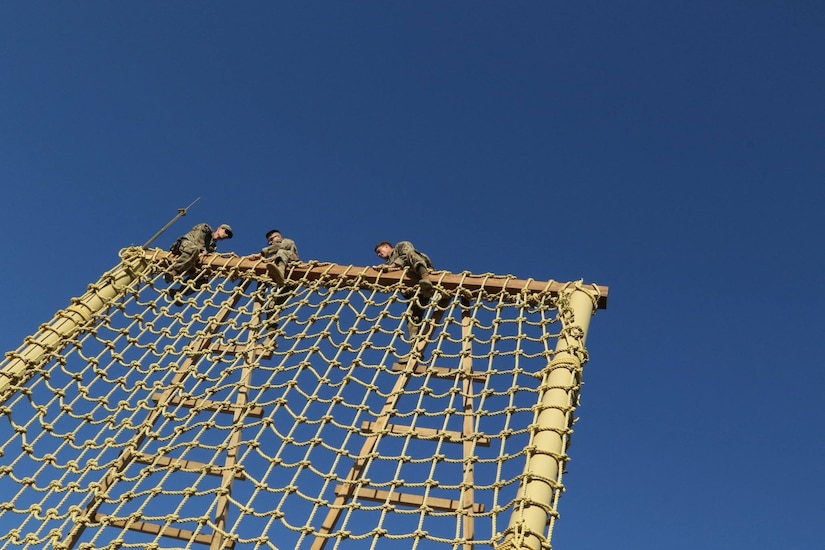 U.S. Servicemembers climb over the top of the ‘Tough One’ obstacle during day zero of U.S. Army Central’s first Air Assault Course, April 4, 2017, at Camp Buehring, Kuwait. The ‘Tough One’ obstacle includes rope, net climbing and walking along wooden planks. It is one of two obstacles candidates must pass in order to continue forward on day zero. The Air Assault Course allows U.S. military personnel in the USARCENT theater of operations the unique opportunity to become air assault qualified, while deployed outside the continental United States.