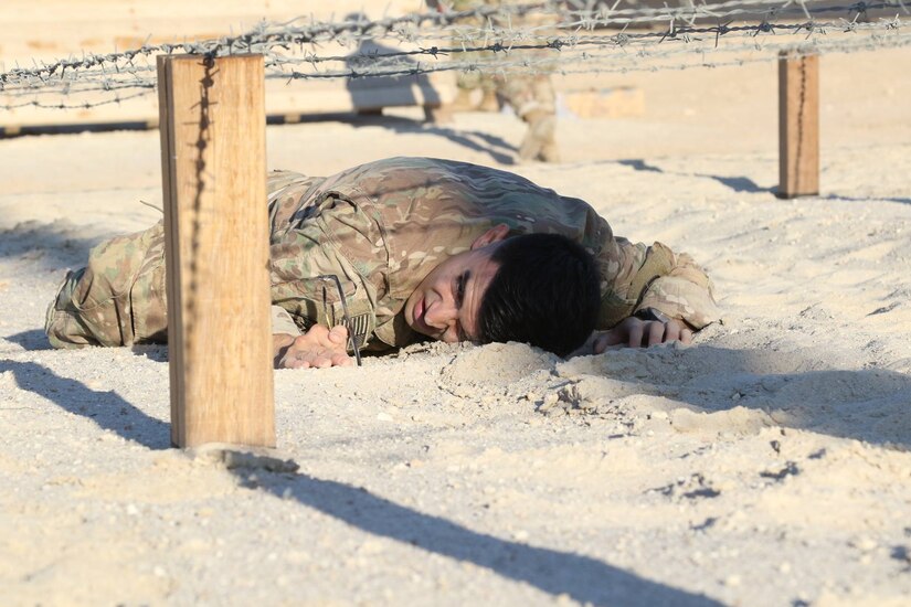 U.S. Army Pfc. Taylor Hunt, infantryman, Headquarters and Headquarters Company, 3rd Brigade Combat Team, 1st Cavalry Division, conducts a belly crawl to clear barb wire during day zero of U.S. Army Central’s first Air Assault Course, April 4, 2017, at Camp Buehring, Kuwait. The Air Assault Course allows U.S. military personnel in the USARCENT theater of operations the unique opportunity to become air assault qualified, while deployed outside the continental United States. “Once completed, the perspective student goes on to become the subject matter expert to their company or unit commander assisting them with planning for air assault operations into whatever environment they may need,” said Capt. Ronald Snyder, Company B commander, Army National Guard Warrior Training Center.