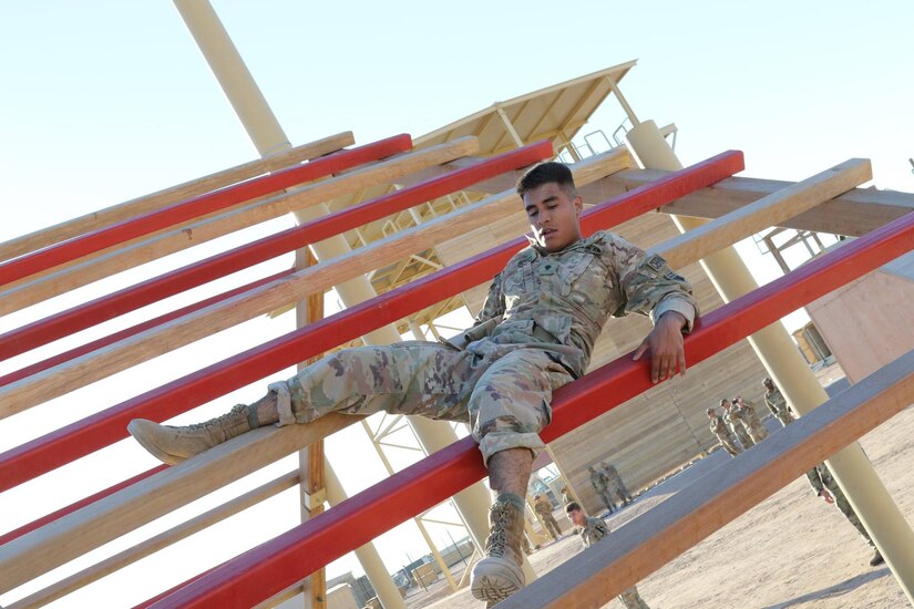 U.S. Army Spc. Pedro Orozco, a chemical, biological, radiological and nuclear specialist, with the 355th Chemical Company, navigates a weave obstacle during day zero of U.S. Army Central’s first Air Assault Course, April 4, at Camp Beuhring, Kuwait. The Air Assault Course, which he is attending, is a 12-day class that allows U.S. military personnel in the USARCENT theater of operations the unique opportunity to become air assault qualified, while deployed outside the continental United States. “Once completed, the perspective student goes on to become the subject matter expert to their company or unit commander assisting them with planning for air assault operations into whatever environment they may need,” said Capt. Ronald Snyder, Company B commander, Army National Guard Warrior Training Center.
