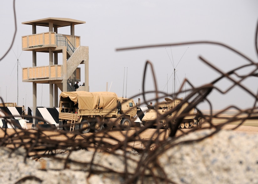 Soldiers with Company B, 3rd Battalion, 157th Field Artillery Regiment, observe an impact zone during a High Mobility Artillery Rocket System gunnery table Vi validation, Udair Range Complex, Kuwait, March 29, 2017. The HIMARS gunnery is a weapon's system qualification for the three Soldiers assigned to each vehicle. (U.S. Army photo by Sgt. Kimberly Browne, USARCENT Public Affairs)