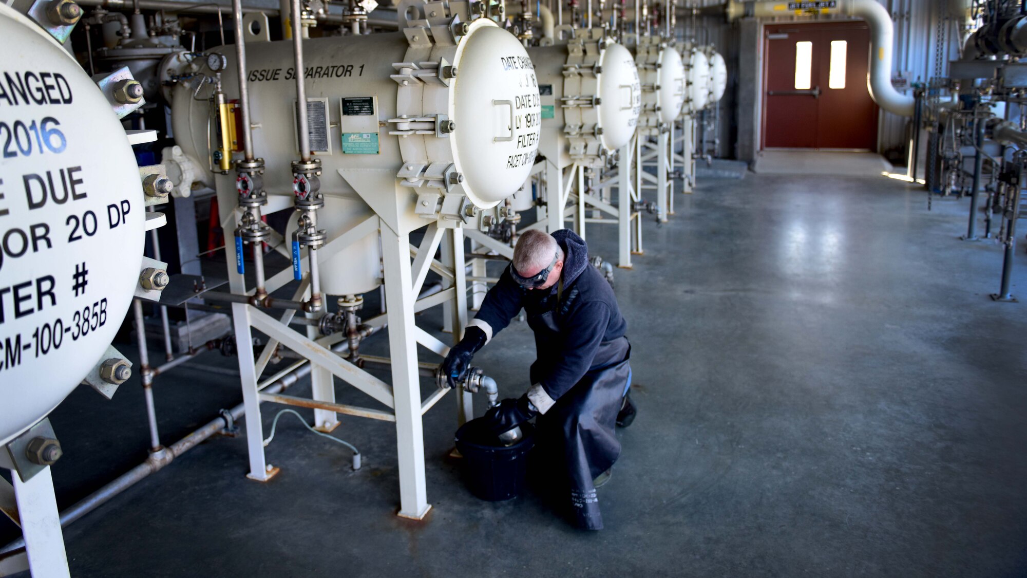 Darryl Hodge, 733rd Logistics Readiness Squadron fuels facilities fuels distribution systems operator, takes a fuel sample at Joint Base Langley-Eustis, Va., April 10, 2017. Much like liquid oxygen, many steps are taken to ensure quality jet fuel is used to power aircraft on base, to include checking the tank that is currently in use, every 24 hours for water. (U.S. Air Force photo/Staff Sgt. Areca T. Bell)