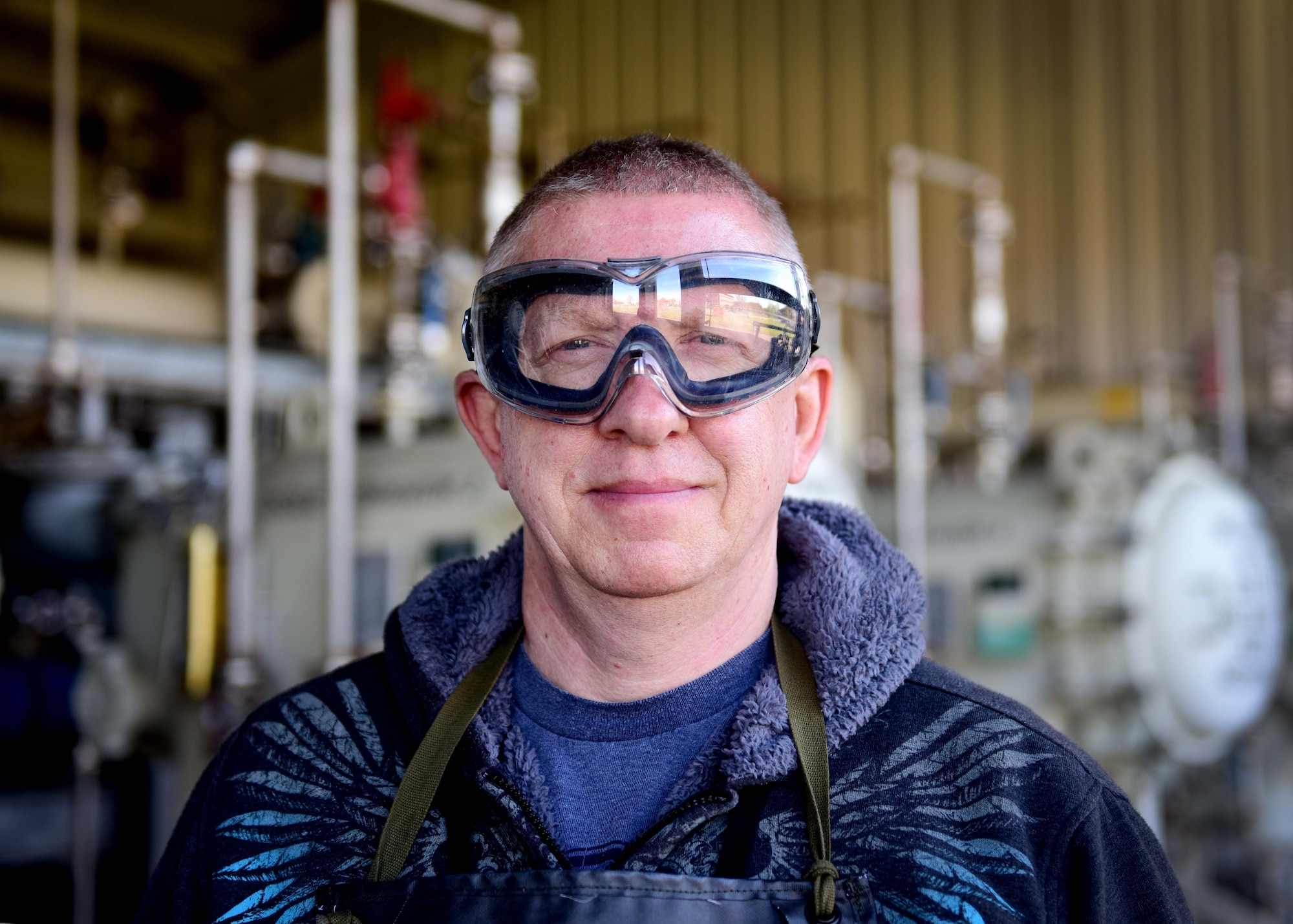 Darryl Hodge, 733rd Logistics Readiness Squadron fuels facilities fuels distribution systems operator, poses for a photo at Joint Base Langley-Eustis, Va., April 10, 2017. Fuels facilities Airmen wear an apron, gloves and googles to protect them from spills that may occur during the fuels sampling process. (U.S. Air Force photo/Staff Sgt. Areca T. Bell)
