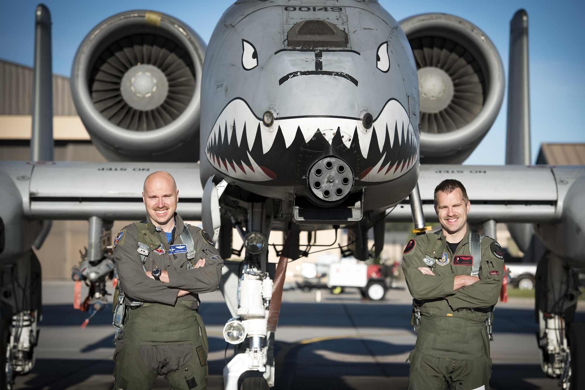 Maj. Matthew Shelly, 23 Wing director of inspections, left, and Capt. Christopher Shelly, 76th Fighter Squadron chief of standards and evaluations, pose for a photo with an A-10C Thunderbolt II, April 8, 2017, at Moody Air Force Base, Ga. The brothers flew in formation together for the first time, fulfilling their childhood dream while also contributing to total force integration, the use of multiple components of the Air Force, which can include active duty, reserve or guard. (U.S. Air Force photo by Airman 1st Class Lauren M. Sprunk)