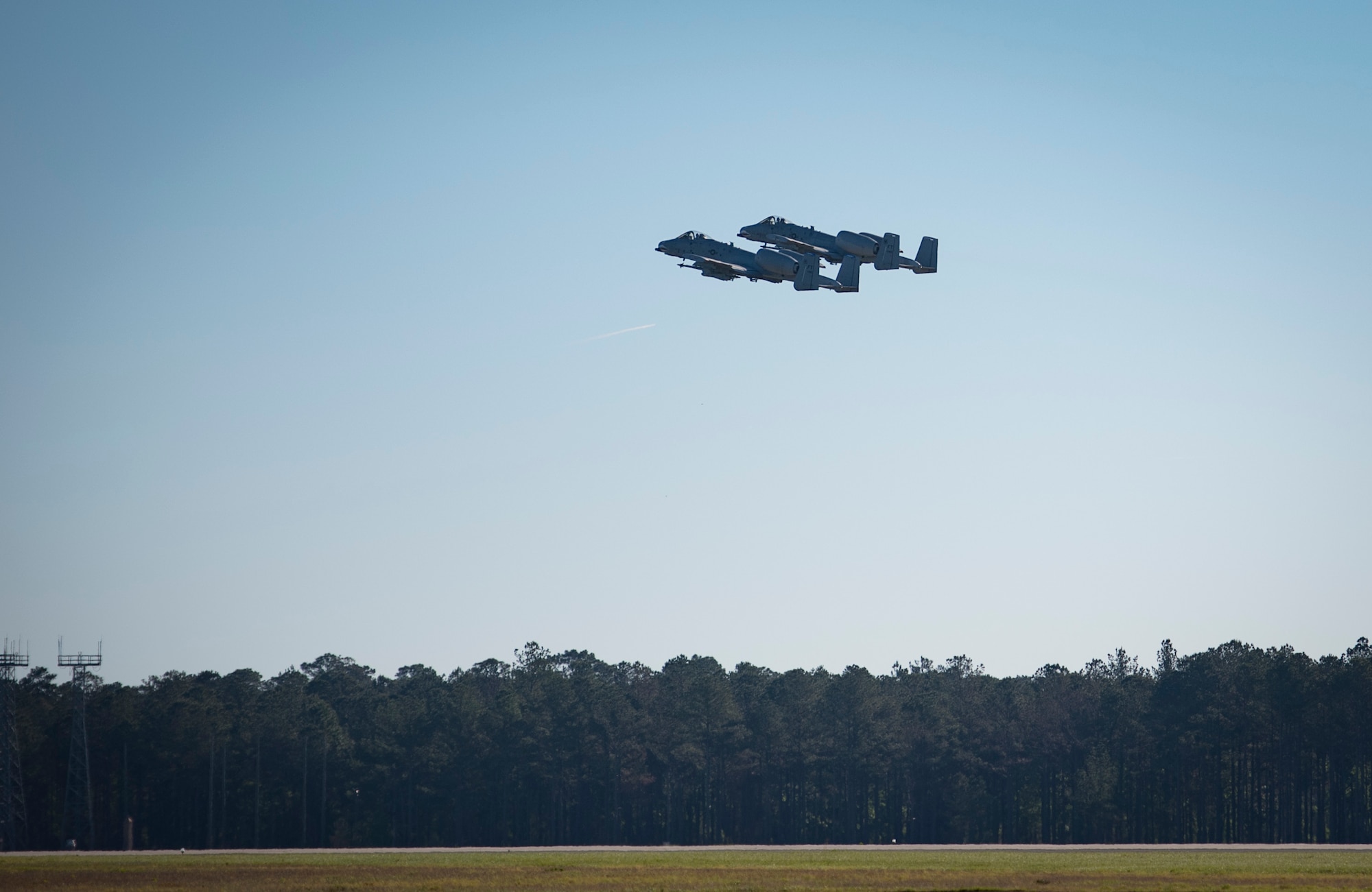 Maj. Matthew Shelly, 23 Wing director of inspections and Capt. Christopher Shelly, 76th Fighter Squadron chief of standards and evaluations, take off in A-10C Thunderbolt IIs, April 8, 2017, at Moody Air Force Base, Ga. The brothers flew in formation together for the first time, fulfilling their childhood dream while also contributing to total force integration, the use of multiple components of the Air Force, which can include active duty, reserve or guard. (U.S. Air Force photo by Airman 1st Class Lauren M. Sprunk)
