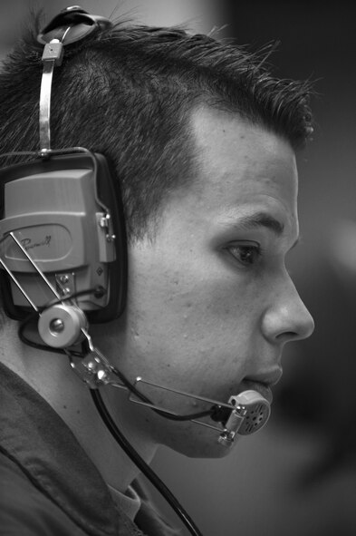 Second Lt. Chris Davis, 321st Missile Squadron deputy missile combat crew commander, speaks to Simulated Electronic Launch-Minuteman test evaluators through his headset inside the launch control center at a missile alert facility in the 90th Missile Wing's missile complex, Neb., April 11, 2017. Davis is originally from West Palm, Fla., and has been with the 321st MS for six months as a missileer. (U.S. Air Force photo by Staff Sgt. Christopher Ruano)