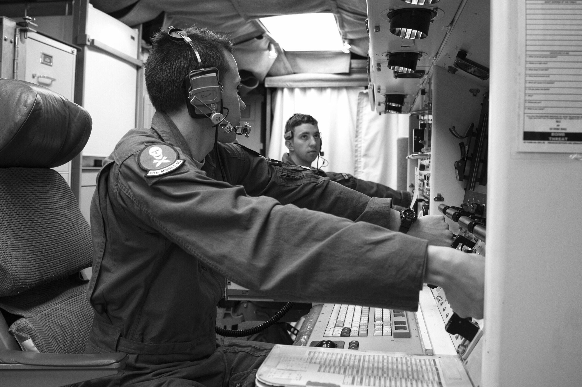 Second Lt. Chris Davis, 321st Missile Squadron deputy missile combat crew commander, and 1st Lt. Paul Lee, 321st MS missile combat crew commander, simulate key turns of the Minuteman III weapon system during a Simulated Electronic Launch-Minuteman test inside the launch control center at a missile alert facility in the 90th Missile Wing's missile complex, Neb., April 11, 2017. The 90th MW contributes to the nation's strategic defense by sustaining and operating 150 Minuteman III ICBMs and the associated launch facilities. A SELM test proves the ICBM weapon system's effectiveness in a safe and secure manner. (U.S. Air Force photo by Staff Sgt. Christopher Ruano)