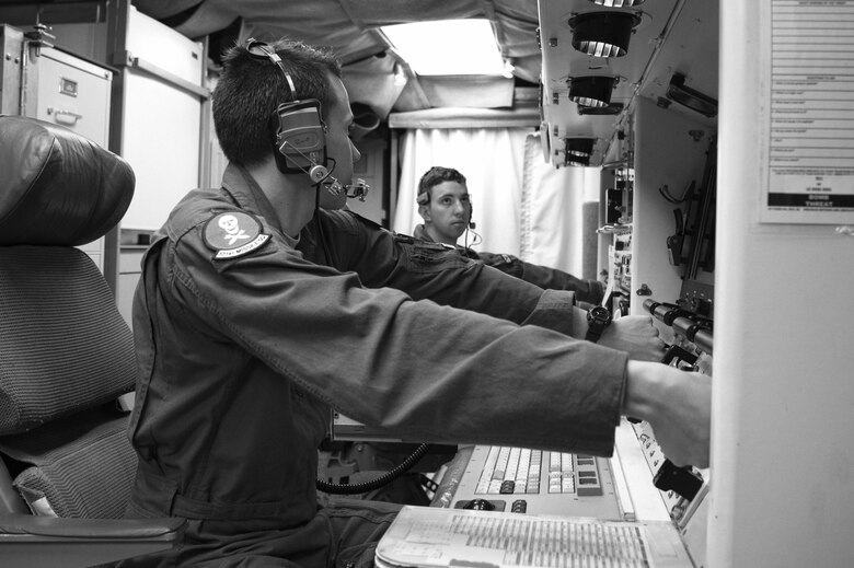 Second Lt. Chris Davis, 321st Missile Squadron deputy missile combat crew commander, and 1st Lt. Paul Lee, 321st MS missile combat crew commander, simulate key turns of the Minuteman III weapon system during a Simulated Electronic Launch-Minuteman test inside the launch control center at a missile alert facility in the 90th Missile Wing's missile complex, Neb., April 11, 2017. The 90th MW contributes to the nation's strategic defense by sustaining and operating 150 Minuteman III ICBMs and the associated launch facilities. A SELM test proves the ICBM weapon system's effectiveness in a safe and secure manner. (U.S. Air Force photo by Staff Sgt. Christopher Ruano)