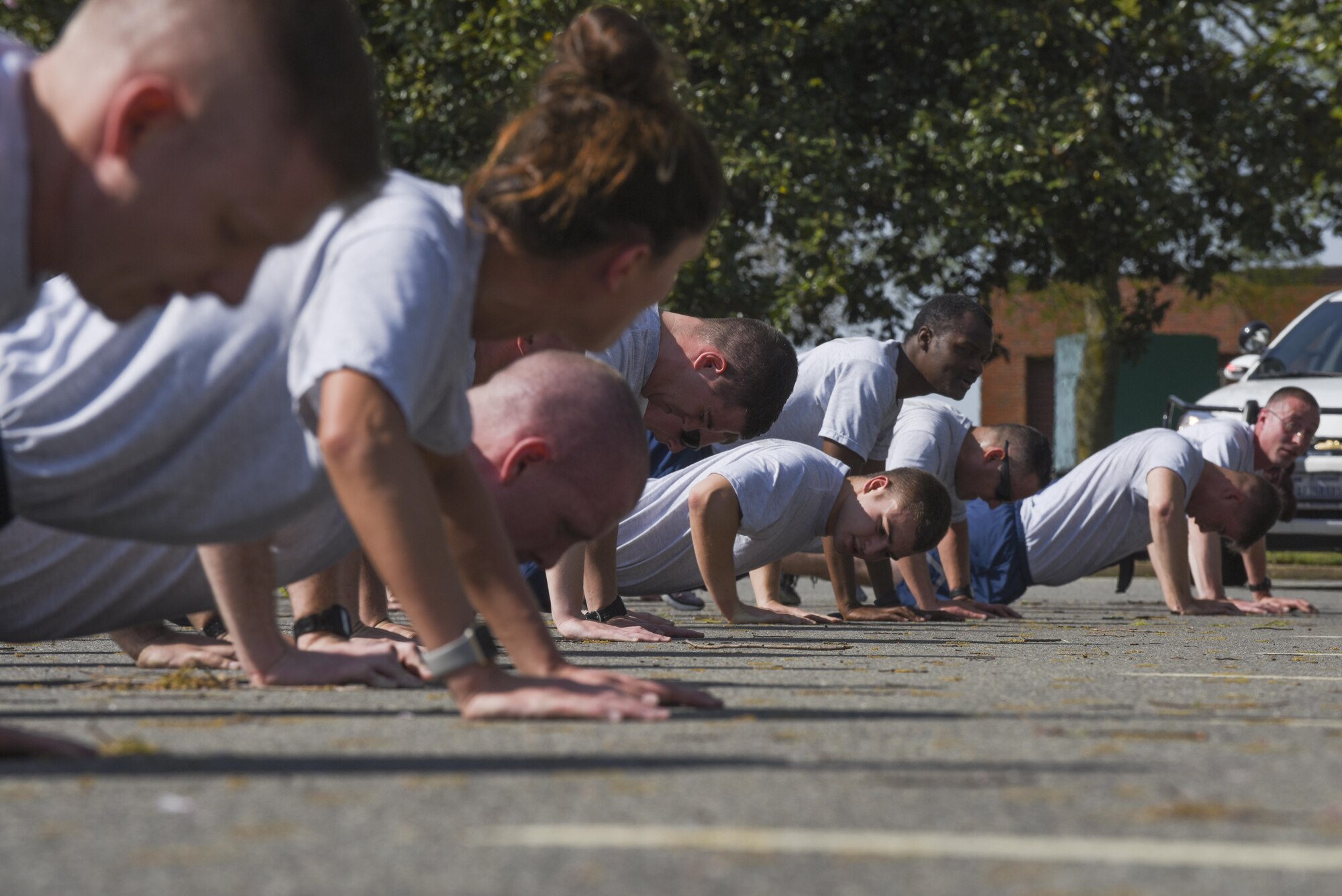 U.S. Air Force Airmen assigned to the 633rd Security Forces Squadron perform push-ups at Joint Base Langley-Eustis, Va., April 12, 2017. During the squadron physical training, the Airmen motivated each other to work harder and maintain excellence. (U.S. Air Force photo/Airman 1st Class Anthony Nin Leclerec)