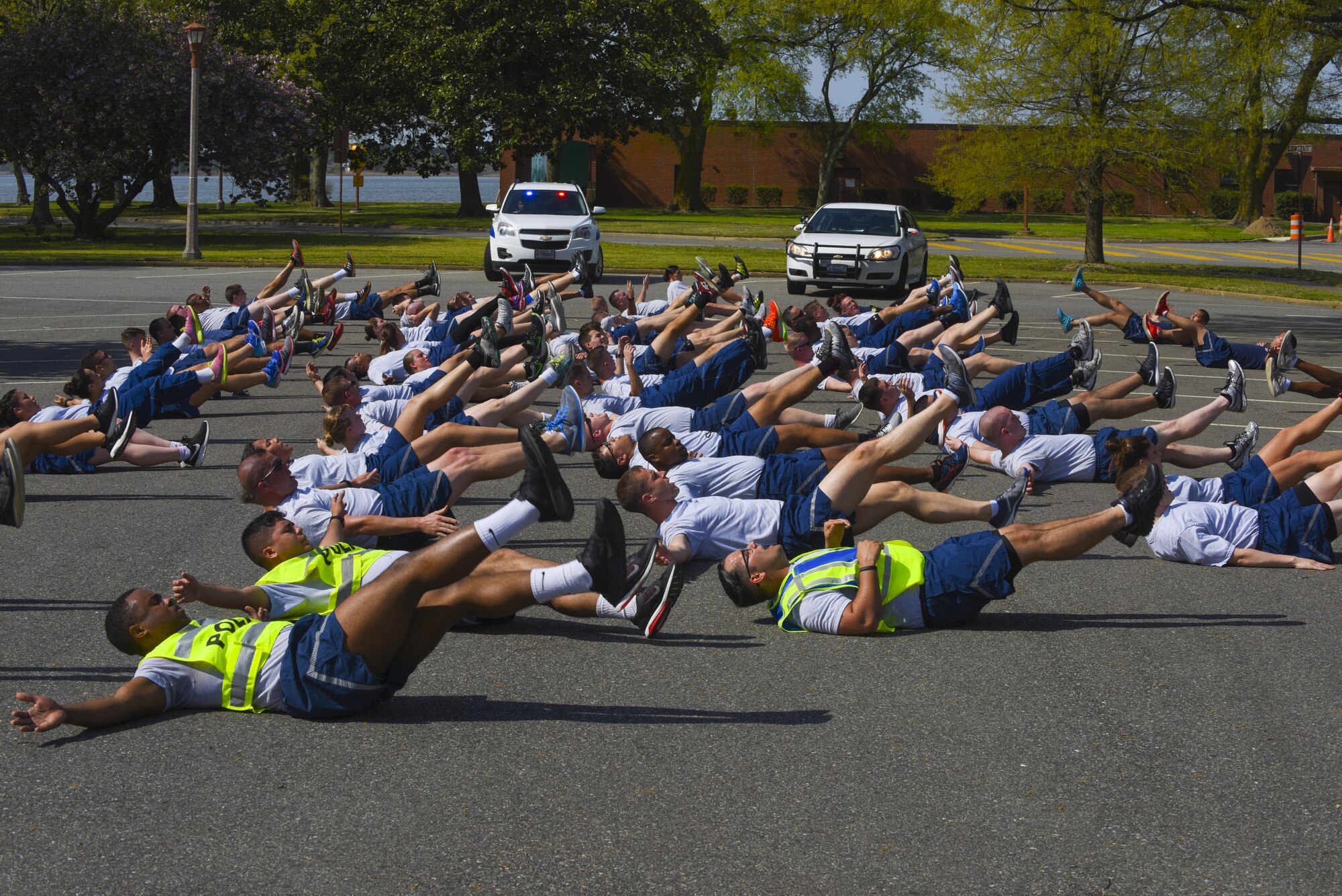 U.S. Air Force Airmen assigned to the 633rd Security Forces Squadron participate in group physical training at Joint Base Langley-Eustis, Va., April 12, 2017. The defenders perform monthly physical training formations to help maintain their mission readiness and to motivate other squadrons. (U.S. Air Force photo/Airman 1st Class Anthony Nin Leclerec)