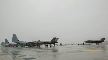 Two U.S. Marine Corps F-35B Lightning II aircraft with Marine Fighter Attack Squadron (VMFA) 121 refuel using a KC-130J Hercules with Marine Aerial Refueler Transport Squadron (VMGR) 152 during aviation delivered ground refueling training at Marine Corps Air Station Iwakuni, Japan, April 11, 2017. The ADGR marked the first evolution of this form of refueling for VMFA-121’s F-35B Lightning II aircraft, and it increases the squadron’s ability to refuel by C-130 aircraft in austere locations when other resources may not be available.  