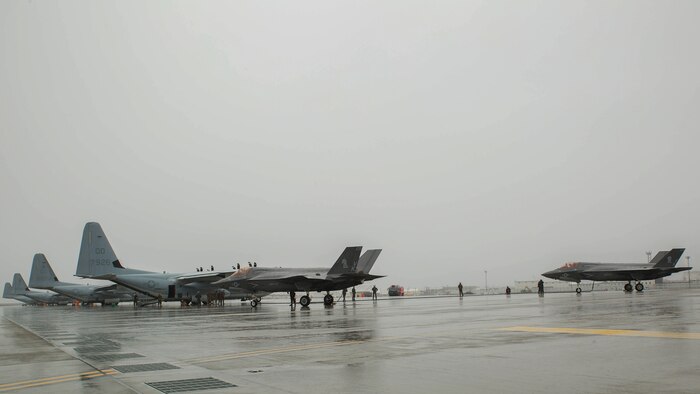 Two U.S. Marine Corps F-35B Lightning II aircraft with Marine Fighter Attack Squadron (VMFA) 121 refuel using a KC-130J Hercules with Marine Aerial Refueler Transport Squadron (VMGR) 152 during aviation delivered ground refueling training at Marine Corps Air Station Iwakuni, Japan, April 11, 2017. The ADGR marked the first evolution of this form of refueling for VMFA-121’s F-35B Lightning II aircraft, and it increases the squadron’s ability to refuel by C-130 aircraft in austere locations when other resources may not be available.  