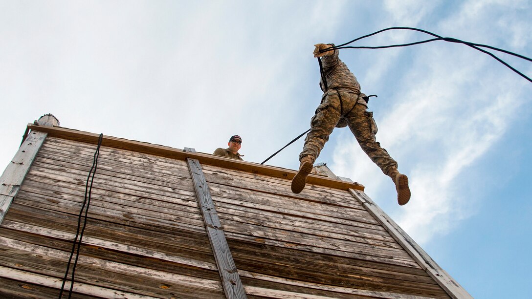 A soldier rappels down the wall at a mountaineering and rappelling event during the 2017 Sapper Stakes Invitational at Camp Butner, N.C., April 8, 2017. The event brought together members of the North Carolina Guard and Reserve Component engineer units to build leadership. The soldier is assigned to 171st Engineer Company, 105th Engineers Battalion. Army photo by Staff Sgt. David McLean