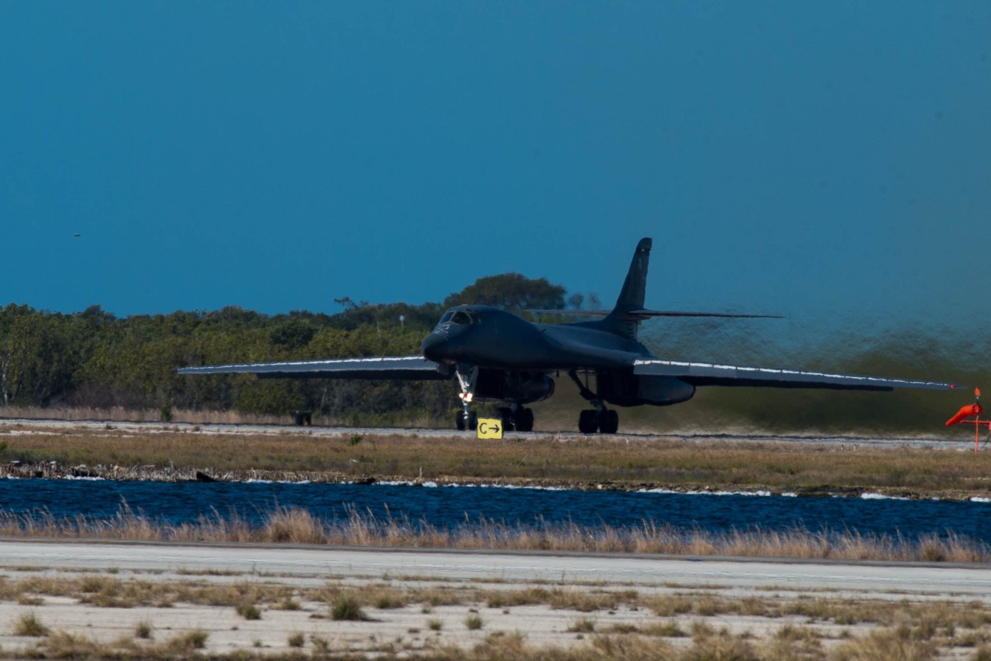 A B-1 Lancer waits for flight clearance at the end of the runway on Boca Chica Naval Air Station, Key West Fla., March 22, 2017. Airmen from the 489th Bomb Group and the 7th Bomb Wing supported the Drug Enforcement Agency, FBI, Coast Guard and 15 other government agencies in the fight against illicit drugs. (U.S. Air Force photo by Staff Sgt. Jason McCasland/released)