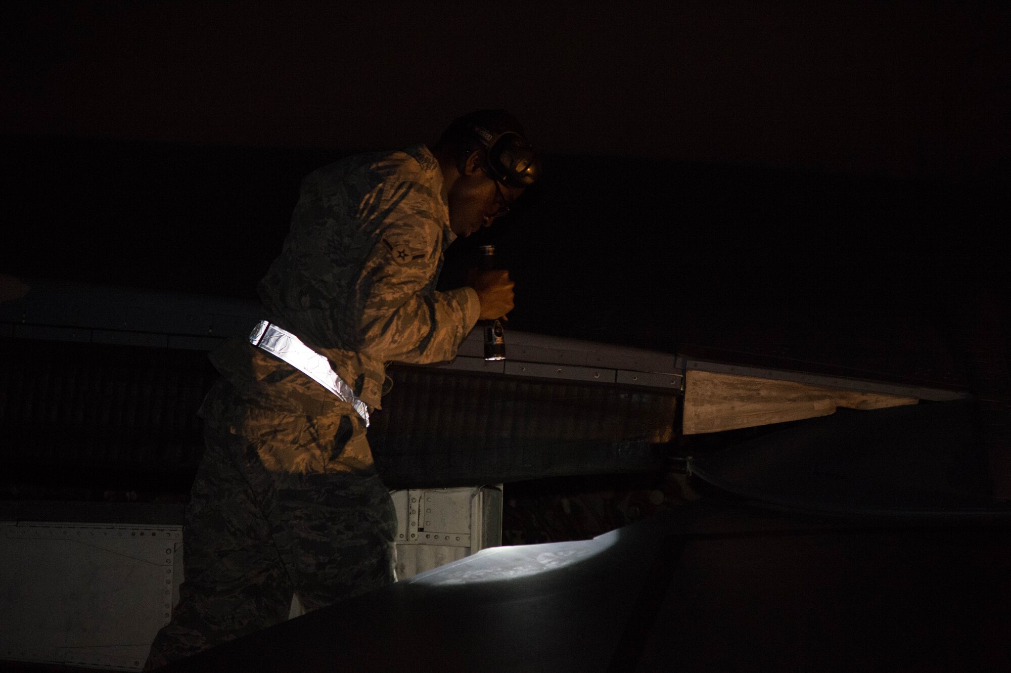 Airman Darian Hopkins, 7th Aircraft Maintenance Squadron instrument and flight controls specialist, inspects a part of the wing of a B-1 Lancer at the Boca Chica Naval Air Station, Key West Fla., March 23, 2017. The B-1 is a four engine, supersonic, variable-sweep wing, jet-powered, strategic bomber. (U.S. Air Force photo by Staff Sgt. Jason McCasland/released)