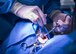 Lt. Col. Clayton Hicks, 96th, Dental Squadron, chief of pediatric dentistry, administers local anesthetic to minimize discomfort during a dental procedure March 31 at Eglin Air Force Base, Fla.  The local anesthetic supports the anesthesiologist’s regulation of pain during the procedure. Out of the 20 active-duty pediatric dentists, Hicks is one of only a few to service special needs children. (U.S. Air Force photo/Ilka Cole)