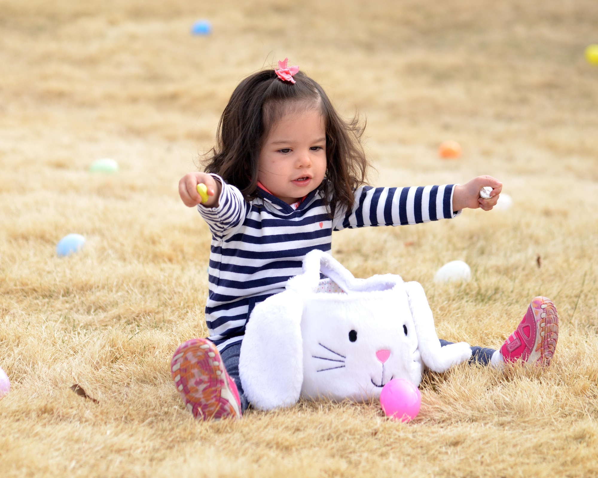 A child displays her loot at last year's Easter egg hunt. Kirtland is offering three separate egg hunts this year, including a new event  call Eggtastic Splash & Dive at the indoor pool.