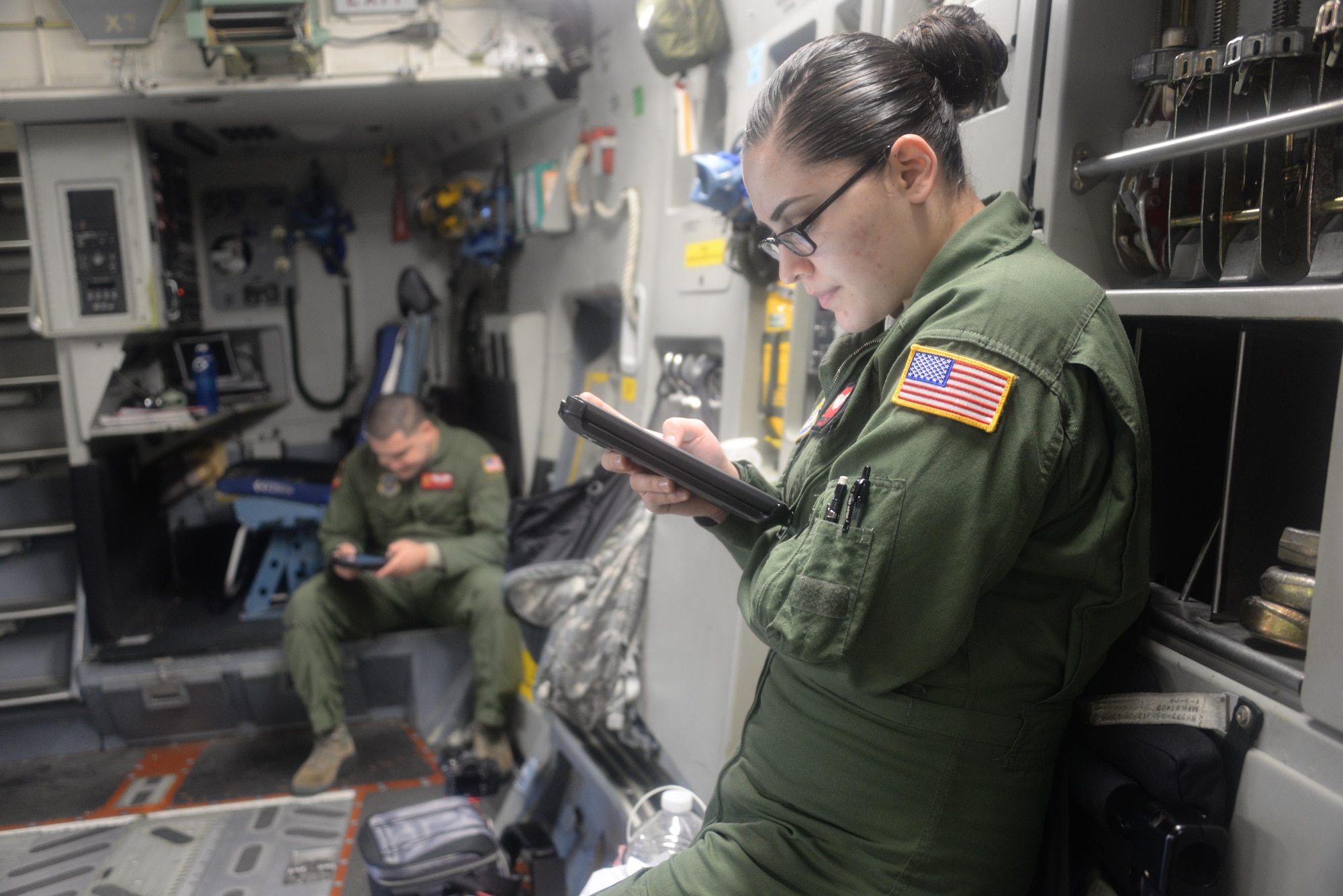 Air Force Senior Airman Miranda Trujillo, 21st Airlift Squadron, makes preparations for a C-17 Globemaster III flight April 7 at Travis Air Force Base, Calif. Members of the 21st AS flew to Yakima Training Center, Washington, and completed a joint training mission with an Army Medevac unit to practice loading UH-60 Black Hawk helicopters. (U.S. Air Force photo / 2nd. Lt. Sarah Johnson)