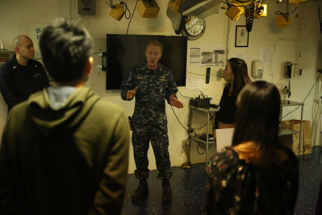 College students from Okinawa, Japan listen to a presentation from Capt. Kurt Eichenmuller, the chief medical officer of the USS Bonhomme Richard (LHD 6) in the Pacific Ocean, March 25, 2017. College students from Okinawa International University, Ryukyu University and Toyo Medical Community College toured the USS Bonhomme Richard (LHD 6) as part of a military exchange experience during the 31st Marine Expeditionary Unit’s 17.1 Spring Patrol of the Indo-Asia-Pacific region. Education programs, such as this military exchange experience, increase cooperation, trust and understanding between the U.S. military and the Okinawan community. As the Marine Corps’ only continuously forward deployed unit, the 31st Marine Expeditionary Unit’s air-ground-logistics team provides a flexible force, ready to perform a wide range of military operations, from limited combat to humanitarian assistance operations, throughout the Asia-Pacific region. (U.S. Marine Corps photo by Sgt. Tiffany Edwards/Released) 