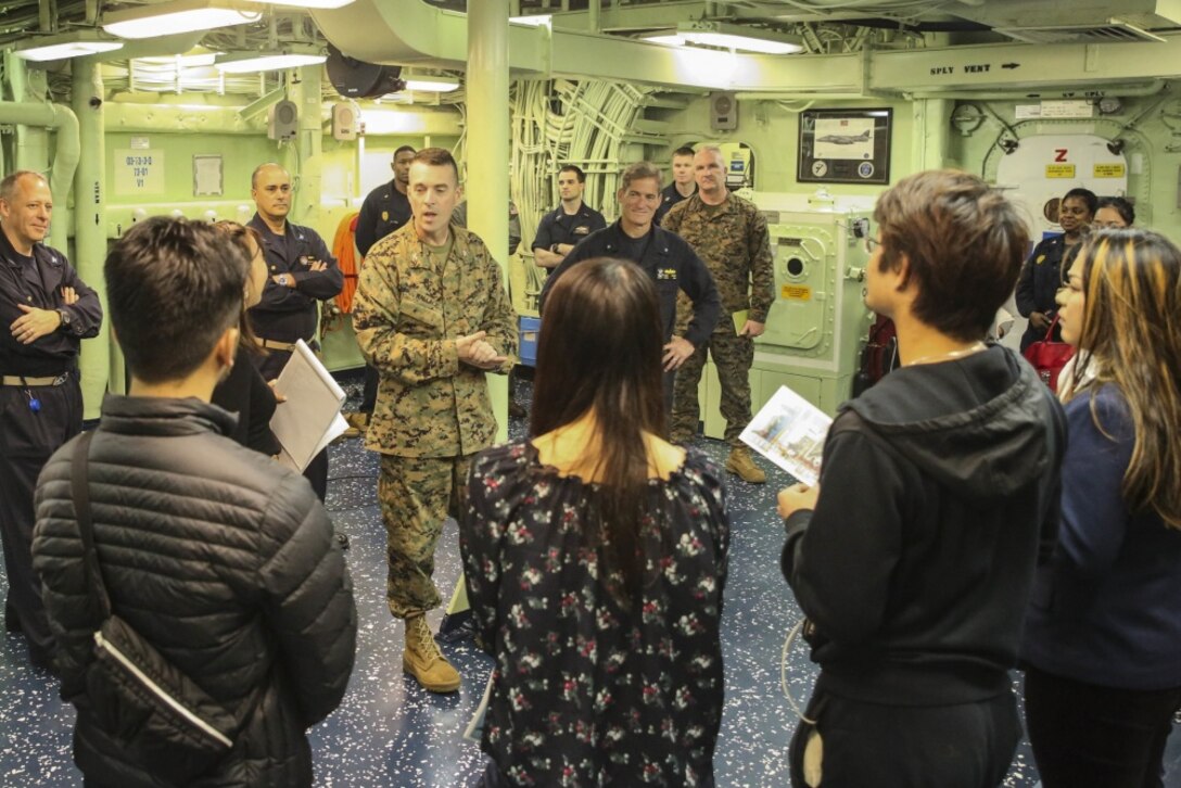 Col. Tye R. Wallace, commanding officer of the 31st Marine Expeditionary Unit, answers questions from Japanese college students aboard the USS Bonhomme Richard (LHD 6) in the Pacific Ocean, March 25, 2017. College students from Okinawa International University, Ryukyu University and Toyo Medical Community College toured the USS Bonhomme Richard (LHD 6) as part of a military exchange experience during the 31st Marine Expeditionary Unit’s 17.1 Spring Patrol of the Indo-Asia-Pacific region. Education programs, such as this military exchange experience, increase cooperation, trust and understanding between the U.S. military and the Okinawan community. As the Marine Corps’ only continuously forward deployed unit, the 31st Marine Expeditionary Unit’s air-ground-logistics team provides a flexible force, ready to perform a wide range of military operations, from limited combat to humanitarian assistance operations, throughout the Asia-Pacific region. (U.S. Marine Corps photo by Sgt. Tiffany Edwards/Released) 