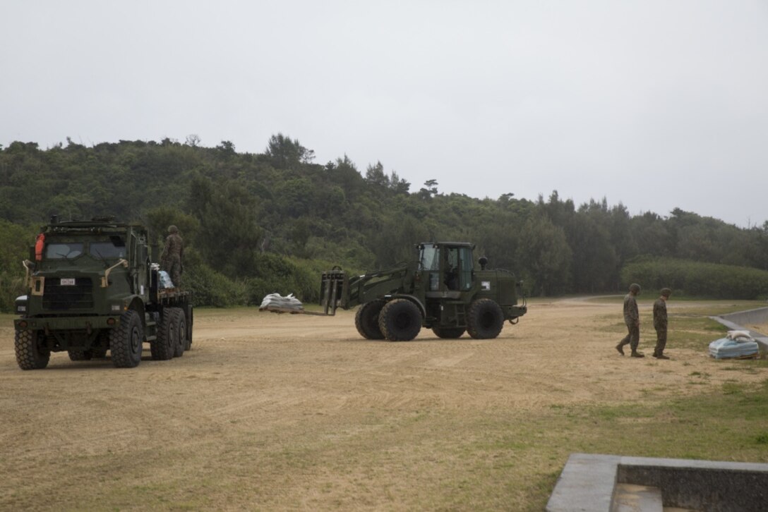 Marines with Combat Logistics Battalion 31, 31st Marine Expeditionary Unit, move pallets of rice at Kin Blue Training Area, Okinawa, Japan, March 26, 2017. The Marines conducted Humanitarian Aid and Disaster Relief training during Certification Exercise for the MEU’s 17.1 Spring Patrol. As the Marine Corps’ only continuously forward deployed unit, the 31st MEU’s air-ground-logistics team provides a flexible force, ready to perform a wide range of military operations, from limited combat to humanitarian assistance operations, throughout the Indo-Asia-Pacific region. (U.S. Marine Corps photo by Lance Cpl. Breanna L. Weisenberger/Released) 