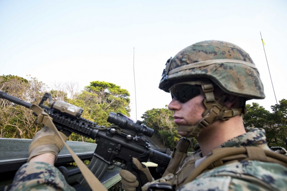 Cpl. Darien J. Bjorndal, a combat photographer with the 31st Marine Expeditionary Unit, provides security from the top hatch of an AAV-P7/A1 assault amphibious vehicle with Echo Co., Battalion Landing Team, 2nd Battalion, 5th Marines, 31st MEU, while participating in mechanized raid at Marine Corps Base Butler, Okinawa, Japan, March 27, 2017. As the Marine Corps' only continuously forward-deployed unit, the 31st MEU air-ground-logistics team provides a flexible force, ready to perform a wide range of military operations, from limited combat to humanitarian assistance operations, throughout the Indo-Asia Pacific region. (U.S. Marine Corps photo by Lance Cpl. M.A. Montelus/Released) 