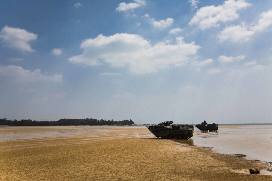 AAV-P7/A1 assault amphibious vehicles with Echo Co., Battalion Landing Team, 2nd Battalion, 5th Marines, 31st Marine Expeditionary Unit, assist in posting security on a beach while participating in mechanized raid at Marine Corps Base Butler, Okinawa, Japan, March 27, 2017. As the Marine Corps' only continuously forward-deployed unit, the 31st MEU air-ground-logistics team provides a flexible force, ready to perform a wide range of military operations, from limited combat to humanitarian assistance operations, throughout the Indo-Asia Pacific region. (U.S. Marine Corps photo by Cpl. Darien J. Bjorndal/Released)