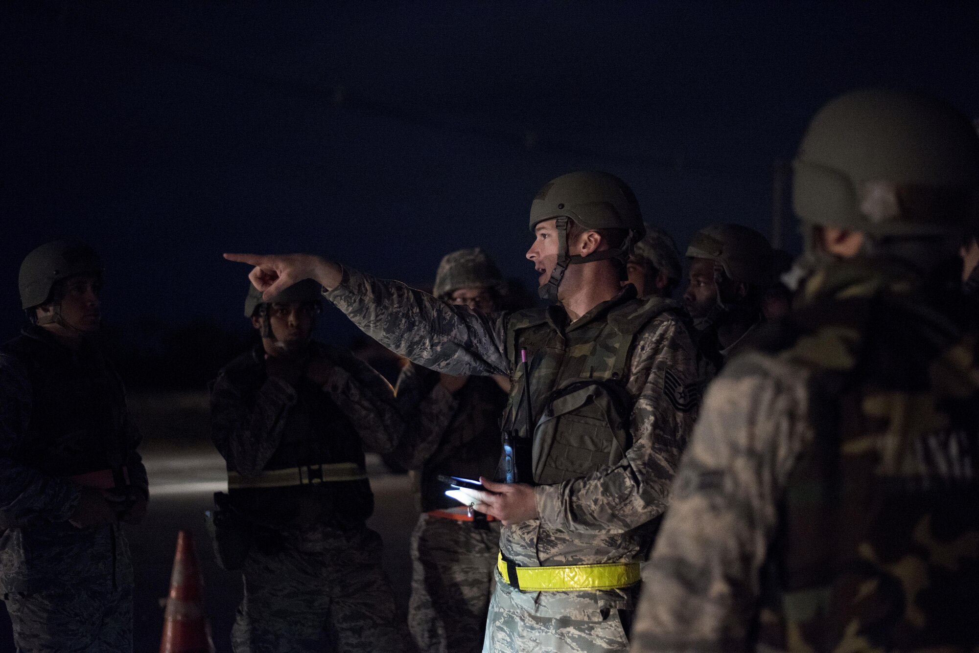 U.S. Air Force Tech. Sgt. Justin Baker, 18th Civil Engineer Squadron NCO in-charge of base maintenance, directs civil engineers during an airfield damage repair portion of a no-notice exercise April 12, 2017, at Kadena Air Base, Japan. As part of the 18th Wing, the 18th CES enables constant aircraft generation by the 18th Wing by maintaining Kadena’s runways. (U.S. Air Force photo by Senior Airman Omari Bernard)