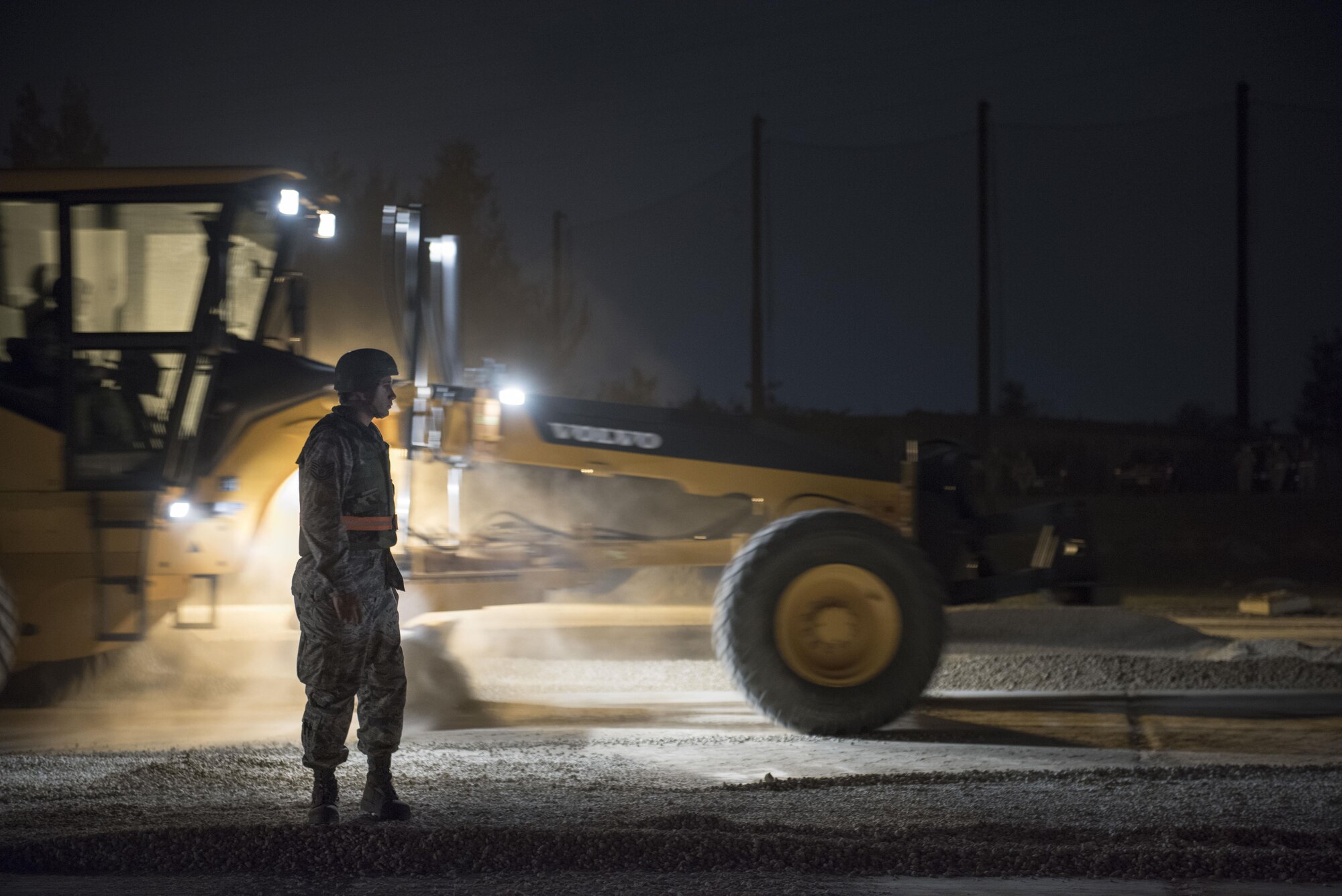 U.S. Air Force Tech. Sgt. Justin Baker, 18th Civil Engineer Squadron NCO in charge of base maintenance, directs heavy machinery operators during the airfield damage repair portion of a no-notice exercise April 12, 2017, at Kadena Air Base, Japan. Each squadron that makes Team Kadena, such as the 18th CES, provides around the clock operational support to enable the 18th Wing to maintain peace and security in the Pacific Theater. (U.S. Air Force photo by Senior Airman Omari Bernard)