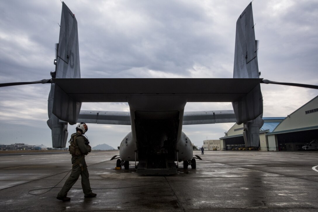 Sgt. Andrew Sturgress, a MV-22B Osprey tiltrotor aircraft crew chief assigned to Marine Medium Tiltrotor Squadron (VMM) 262, 31st Marine Expeditionary Unit, conducts his pre-flight inspections at Oruma Air Base, Nagasaki, Japan, Nov. 18, 2016. The aircraft flew from the island of Okinawa, conducted simulated humanitarian aid with the Japan Maritime Self-Defense Force (JMSDF) at multiple locations and was refueled by JMSDF personnel before returning to Okinawa. Sturgess is a native of Sidney, Illinois. (U.S. Marine Corps photo by Cpl. Darien J. Bjorndal, 31st Marine Expeditionary Unit/ Released) 