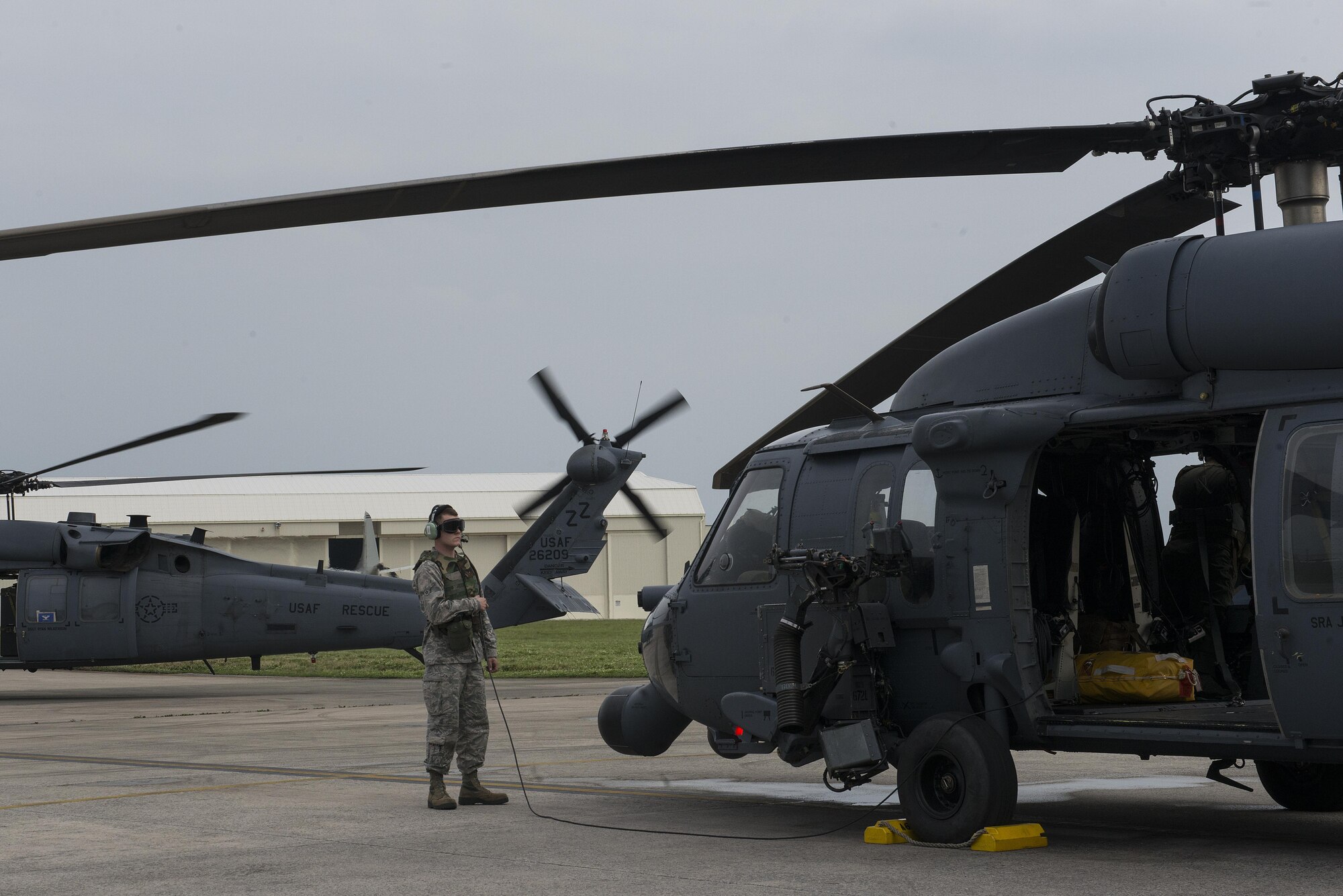 A U.S. Air Force Airman runs through pre-flight procedures of a 33rd Rescue Squadron HH-60 Pave Hawk during a training exercise April 12, 2017, at Kadena Air Base, Japan. Maintaining operational readiness is essential for the 18th Wing to be able to respond to any natural disaster or adversarial threat in the region. (U.S. Air Force photo by Senior Airman John Linzmeier)