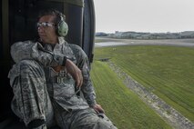 U.S. Air Force Brig. Gen. Barry Cornish, 18th Wing commander, rides in a 33rd Rescue Squadron HH-60 Pave Hawk during an elephant walk show of force April 12, 2017, at Kadena Air Base, Japan. Operating from the largest U.S. installation in the Asia-Pacific region, the 18th Wing defends U.S. and Japanese interests by providing a forward power projection platform with integrated, deployable combat power.  (U.S. Air Force photo by Senior Airman John Linzmeier)