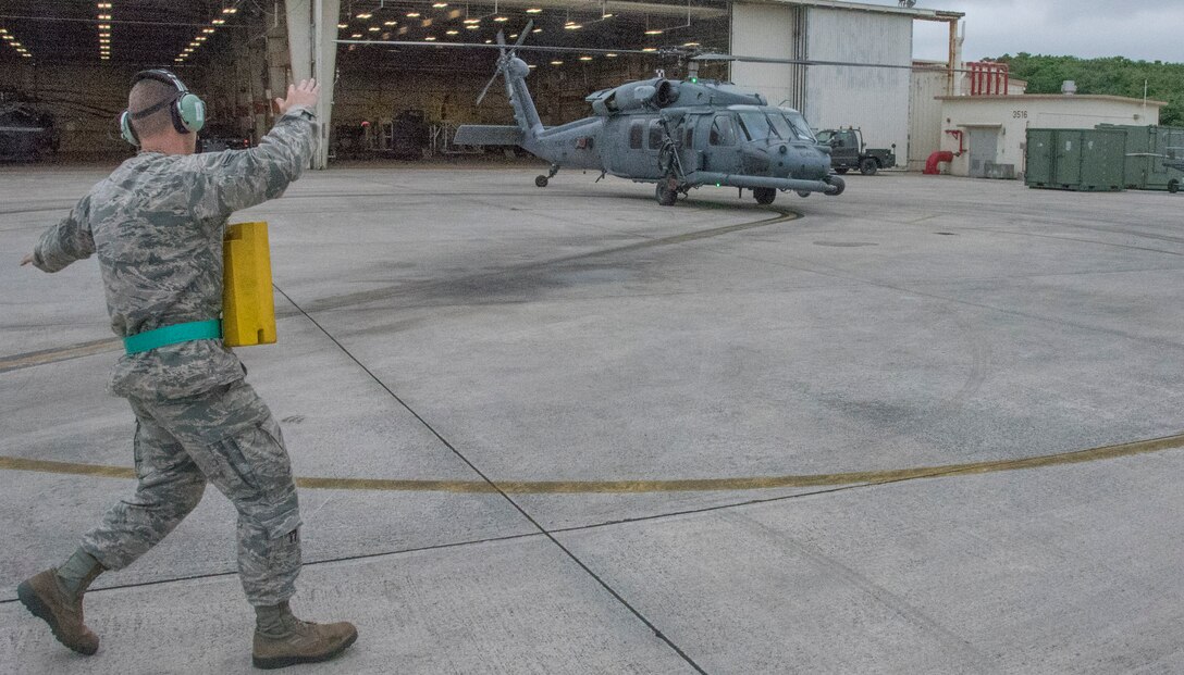 A U.S. Air Force 33rd Aircraft Maintenance Unit Airman marshals a 33rd Rescue Squadron HH-60 Pave Hawk onto the flightline during a training sortie April 11, 2017, at Kadena Air Base, Japan. The 18th Wing and tenant units operate as the largest U.S. installation in the Indo-Asia-Pacific Theater to defend Japan and other allies in the region with fully integrated, deployable combat power. (U.S. Air Force photo by Senior Airman John Linzmeier)