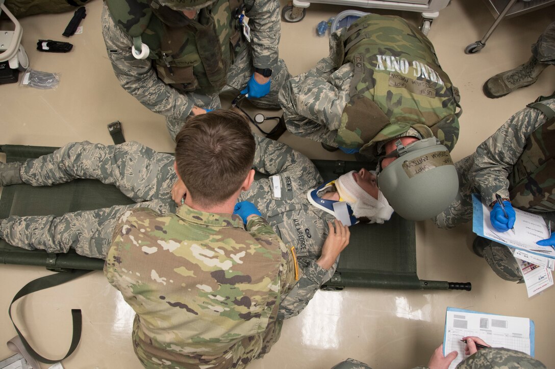 U.S. Air Force Airmen and Army Soldiers practice life-saving techniques on a simulated casualty during a training exercise April 12, 2017, at Kadena Air Base, Japan. Airmen are entrusted with leading decisively, especially in times of stress and emergency and are trained to seamlessly integrate joint and allied forces into Kadena's operations. (U.S. Air Force photo by Senior Airman John Linzmeier)