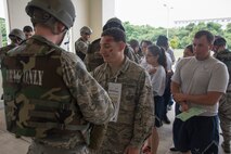 U.S. Air Force Airmen acting as casualties from a simulated attack are processed through a line during a training exercise April 12, 2017, at Kadena Air Base, Japan. Airmen are entrusted with leading decisively, especially in times of stress and emergency and are trained to seamlessly integrate joint and allied forces into Kadena's operations. (U.S. Air Force photo by Senior Airman John Linzmeier)
