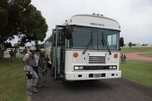U.S. Air Force Airmen help a simulated casualty onto a bus as part of a training exercise April 12, 2017, at Kadena Air Base, Japan. Exercises test the capabilities and readiness of participating units and to demonstrate Team Kadena's capability to respond to any crisis at a moment's notice. (U.S. Air Force photo by Senior Airman John Linzmeier)