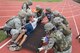 U.S. Air Force Airmen roll a simulated casualty onto a litter during a training exercise April 12, 2017, at Kadena Air Base, Japan. Airmen are entrusted with leading with tact; especially in times of stress and emergency and are trained to fully integrate joint and allied forces into Kadena's operations. (U.S. Air Force photo by Senior Airman John Linzmeier)