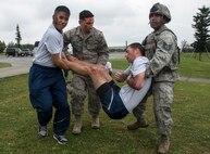 U.S. Air Force Airmen carry a victim of a simulated attack as part of a mass casualty exercise April 12, 2017, at Kadena Air Base, Japan. Exercises including the entire installation are conducted and designed to test the capabilities and readiness of participating units, keeping Airmen ready to perform their jobs in a variety of potentially real-world scenarios. (U.S. Air Force photo by Senior Airman John Linzmeier)