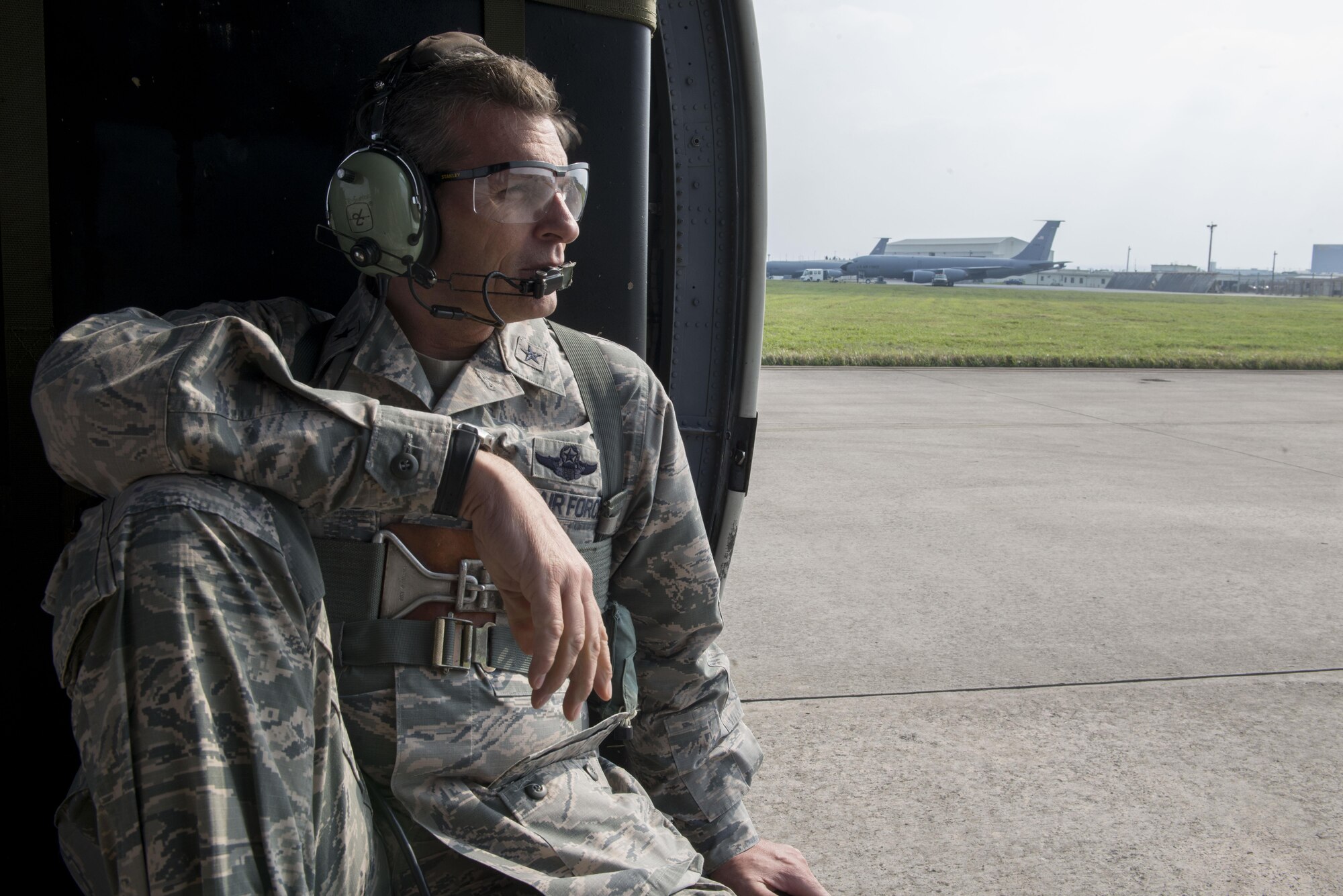U.S. Air Force Brig. Gen. Barry Cornish, 18th Wing commander, rides in a 33rd Rescue Squadron HH-60 Pave Hawk during an elephant walk show of force April 12, 2017, at Kadena Air Base, Japan. Operating from the largest U.S. installation in the Asia-Pacific region, the 18th Wing defends U.S. and Japanese interests by providing a forward power projection platform with integrated, deployable combat power.  (U.S. Air Force photo by Senior Airman John Linzmeier)