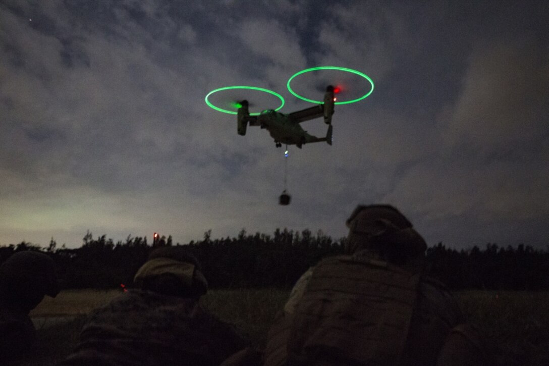 Marines assigned to Landing Support Platoon, Combat Logistics Battalion 31, 31st Marine Expeditionary Unit, observe a MV-22B Osprey tiltrotor aircraft from Marine Medium Tiltrotor Squadron 262 (Reinforced), 31st MEU, during external lift operations training at Landing Zone Falcon, Okinawa, Japan, Dec. 8, 2016. The units conducted the training to complete qualifications for the 31st MEU's upcoming spring deployment. As the Marine Corps' only continuously forward-deployed unit, the 31st MEU’s air-ground-logistics team provides a flexible force, ready to perform a wide range of military operations, from limited combat to humanitarian assistance operations, throughout the Indo-Asia-Pacific region. (U.S. Marine Corps photo by Cpl. Darien J. Bjorndal, 31st Marine Expeditionary Unit/ Released)