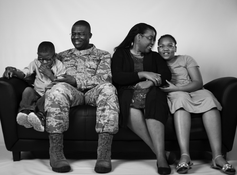 U.S. Air Force Chief Master Sgt. Henry Hayes, Air Combat Command first sergeant, poses for a photo with his family at Joint Base Langley-Eustis, Va., March 27, 2017. Hayes and his wife, Stephanie, provide foster care for children, which led them to the adoption of two of their children. (U.S. Air Force photo/Staff Sgt. Natasha Stannard)