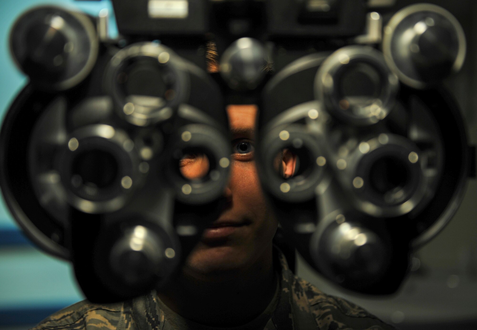 U.S. Air Force Staff Sgt. River Carson, 8th Medical Operations Squadron public health technician, stares through the phoropter at a letter chart during his eye exam at Kunsan Air Base, Republic of Korea, March 24, 2017. The phoropter checks for refractive errors in the eyes and assists in eye glass prescriptions.  (U.S. Air Force photo by Senior Airman Colville McFee/Released)